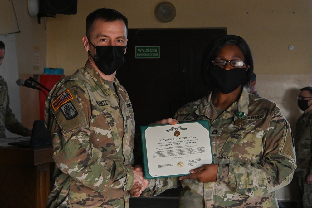 Alaska Army National Guard Sergeant 1st Class Julena Felix, 297th Regional Support Group, receives an Army Commendation Medal.
