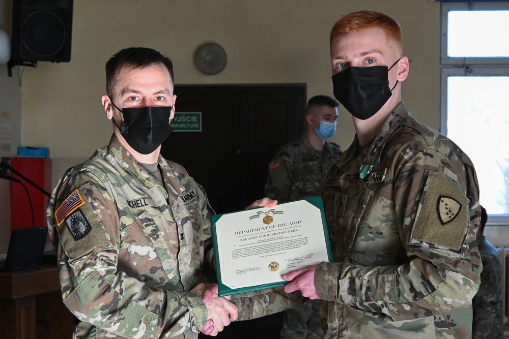 Alaska Army National Guard Specialist Matthew Goudy, 297th Regional Support Group, receives an Army Commendation Medal.