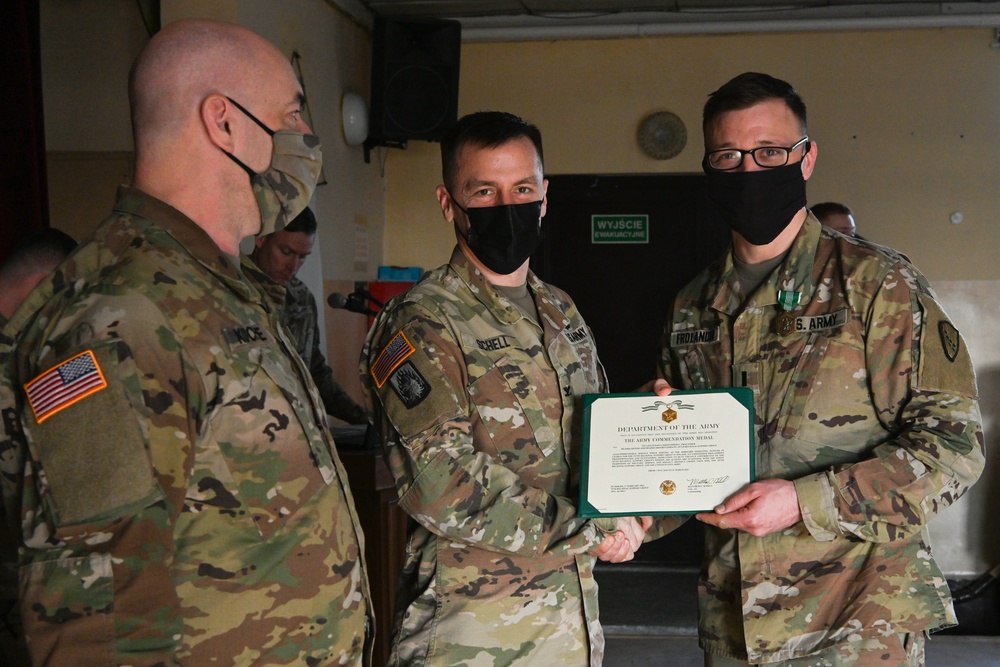 Alaska Army National Guard First Lieutenant Christopher Frolander, 297th Regional Support Group, receives an Army Commendation Medal