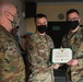 Alaska Army National Guard First Lieutenant Christopher Frolander, 297th Regional Support Group, receives an Army Commendation Medal