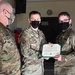 Alaska Army National Guard Specialist Hunter Mains, 297th Regional Support Group, receives an Army Commendation Medal.