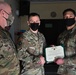 Alaska Army National Guard First Lieutenant Kenneth McCoy, 297th Regional Support Group, receives an Army Commendation Medal.