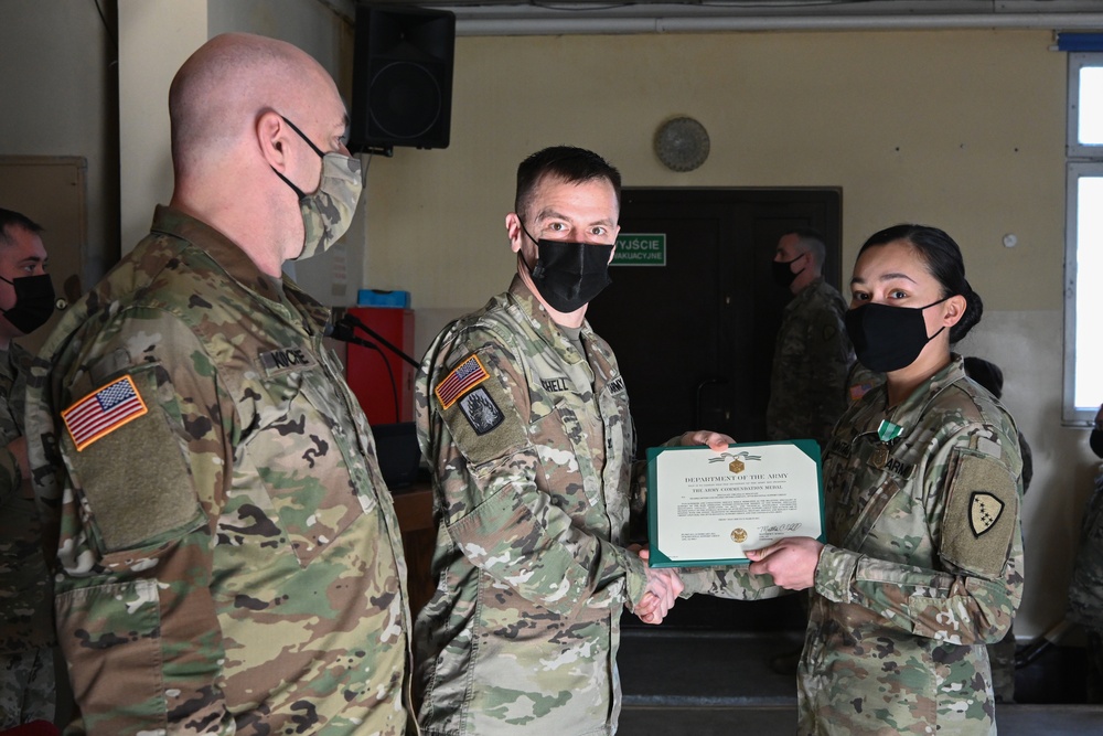 Alaska Army National Guard Specialist Virginia Mountain, 297th Regional Support Group, receives an Army Commendation Medal.