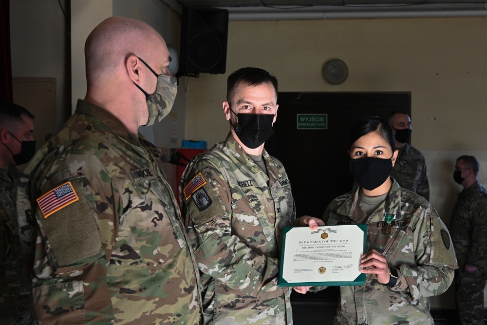 Alaska Army National Guard Staff Sergeant Yvonne Munoz, 297th Regional Support Group, receives an Army Commendation Medal.