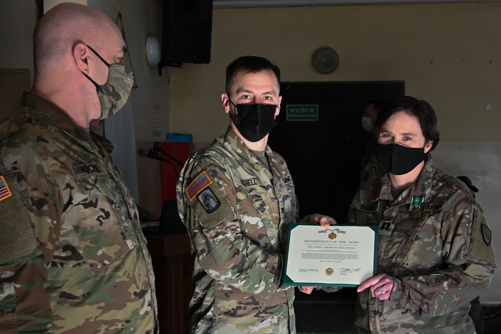 Alaska Army National Guard Captain Jamia Odom, 297th Regional Support Group, receives an Army Commendation Medal.