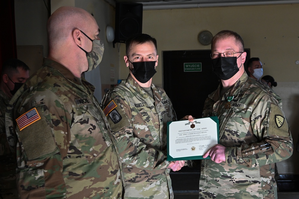 Alaska Army National Guard Sergeant 1st Class Paul Oliver, 297th Regional Support Group, receives an Army Commendation Medal.