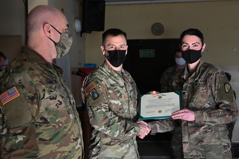 Alaska Army National Guard Specialist Nicole Raabe, 297th Regional Support Group, receives an Army Commendation Medal.