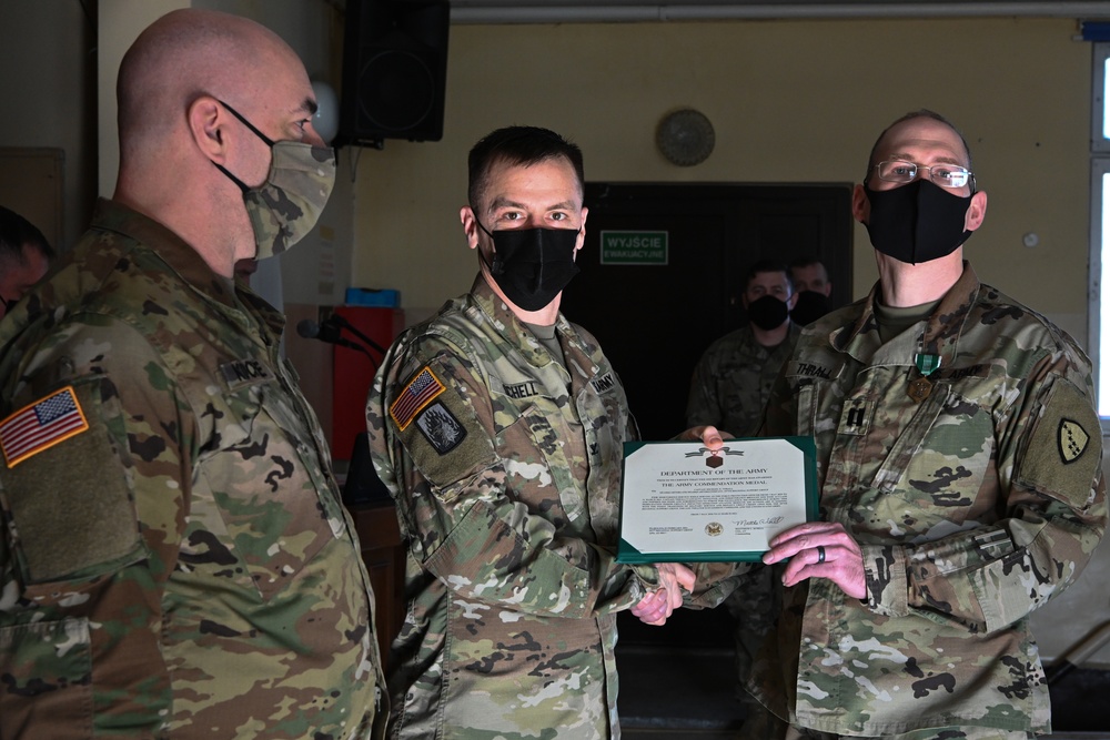 Alaska Army National Guard Captain Michael Thrall, 297th Regional Support Group, receives an Army Commendation Medal.