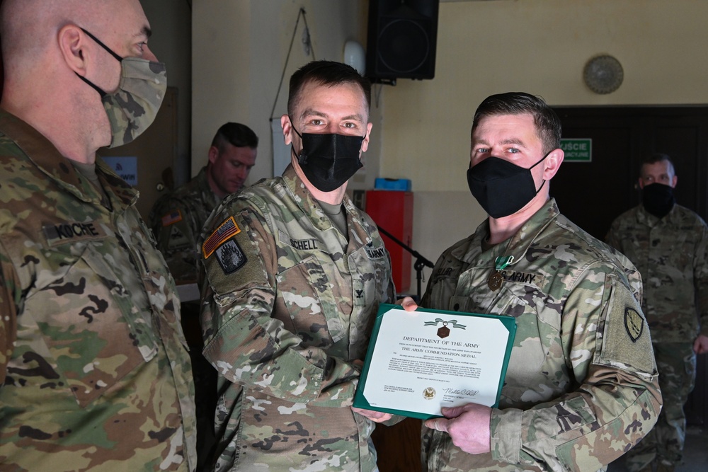 Alaska Army National Guard Specialist Jeremy Weller, 297th Regional Support Group, receives an Army Commendation Medal.