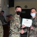 Alaska Army National Guard Sergeant 1st Class Brandon Amerone, 297th Regional Support Group, receives an Army Achievement Medal.