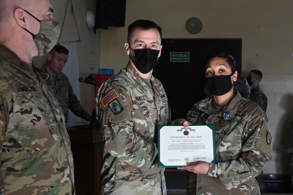 Alaska Army National Guard Staff Sergeant Domingo, 297th Regional Support Group, receives an Army Achievement Medal.