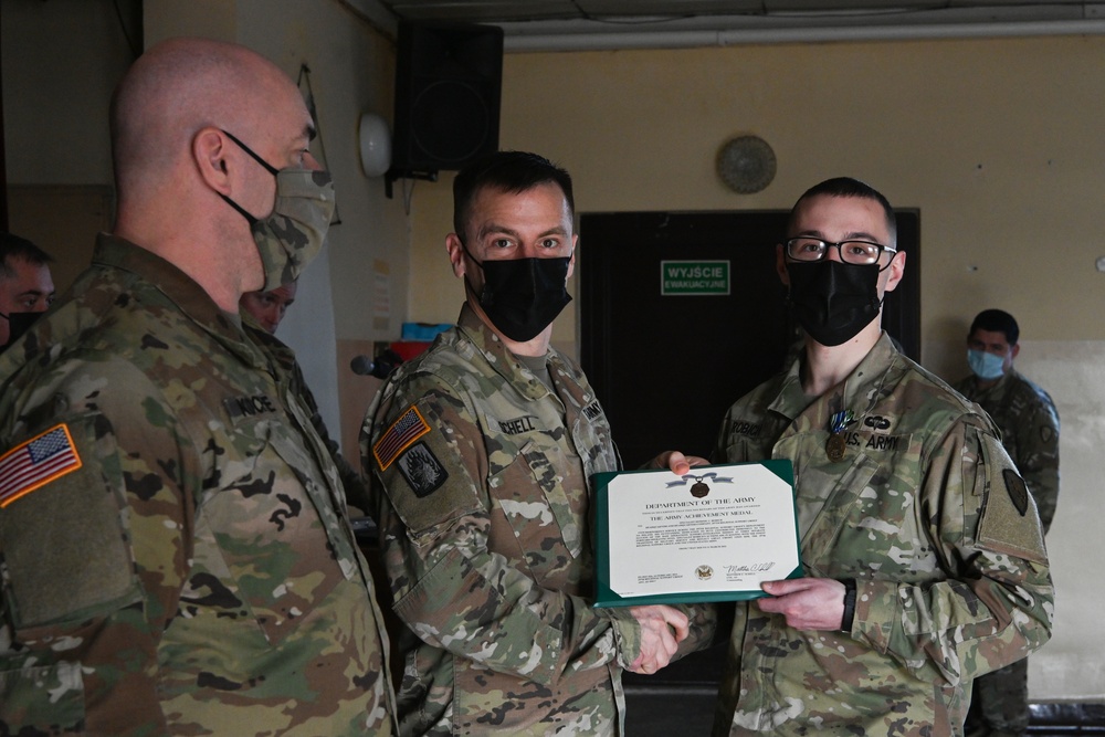Alaska Army National Guard Specialist Dominic Robich, 297th Regional Support Group, receives an Army Achievement Medal.