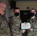 Alaska Army National Guard Specialist Dominic Robich, 297th Regional Support Group, receives an Army Achievement Medal.