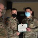 Alaska Army National Guard Specialist Drew Yeager, 297th Regional Support Group, receives an Army Achievement Medal.