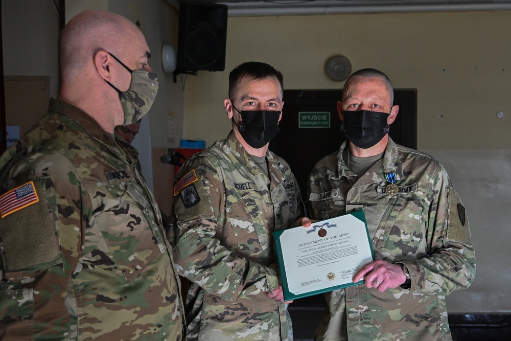 Alaska Army National Guard Sergeant 1st Class Robert Sapp, 297th Regional Support Group, receives an Army Achievement Medal.
