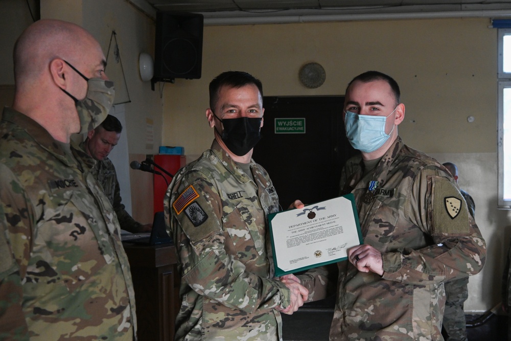 Alaska Army National Guard Specialist Devin Greenway, 297th Regional Support Group, receives an Army Achievement Medal.