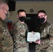 Alaska Army National Guard Specialist Hunter Mains, 297th Regional Support Group, receives an Army Achievement Medal.