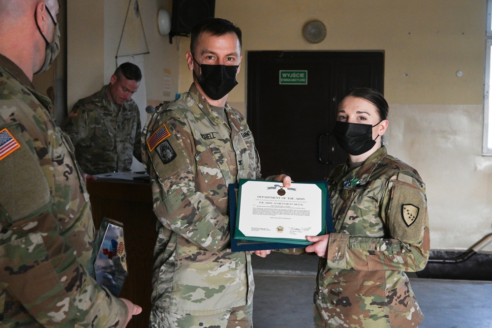 Alaska Army National Guard Specialist Delaney Pletsch, 297th Regional Support Group, receives an Army Achievement Medal.