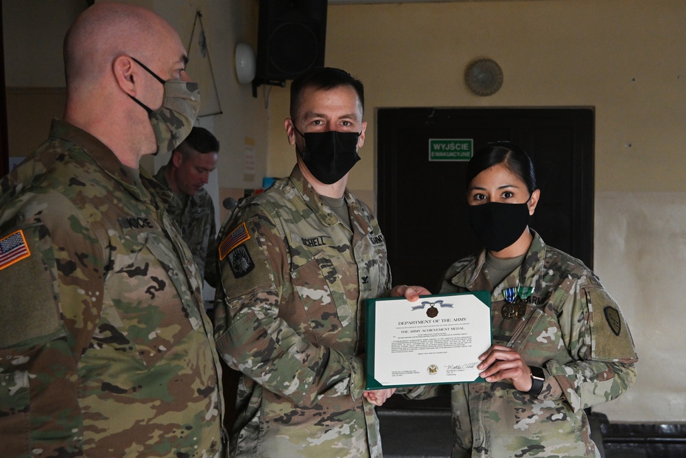 Alaska Army National Guard Staff Sergeant Yvonne Munoz, 297th Regional Support Group, receives an Army Achievement Medal.