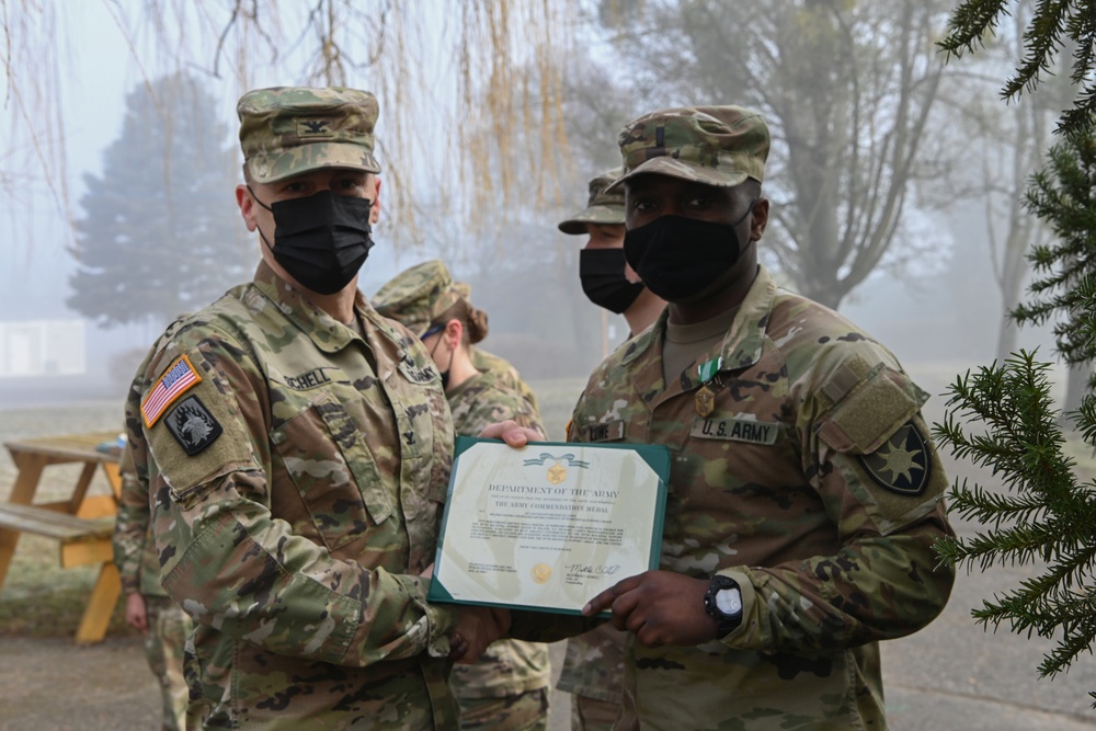 Alaska Army National Guard First Lieutenant Michael Lowe, 297th Regional Support Group, receives an Army Commendation Medal.