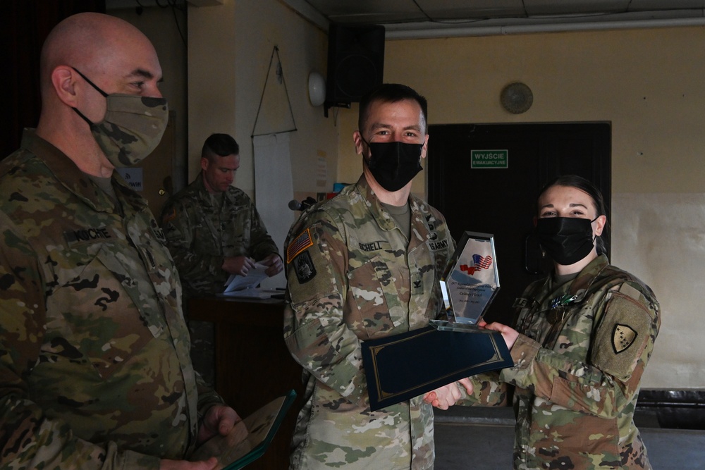Alaska Army National Guard Specialist Delaney Pletsch, 297th Regional Support Group, received a plaque for Soldier of the Deployment,
