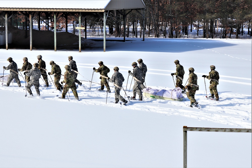 Fort McCoy CWOC class 21-04 students conduct field training in snowshoes, pulling sleds