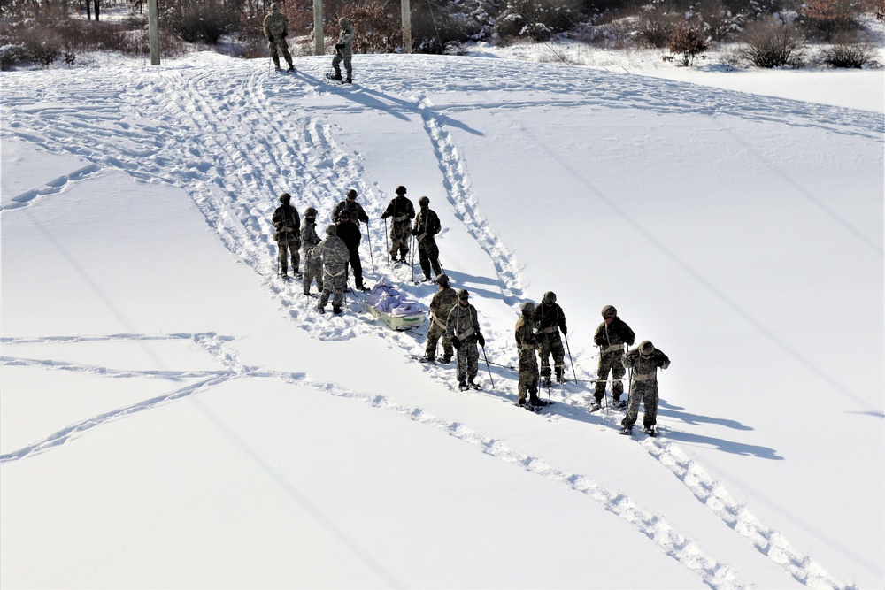 Fort McCoy CWOC class 21-04 students conduct field training in snowshoes, pulling sleds