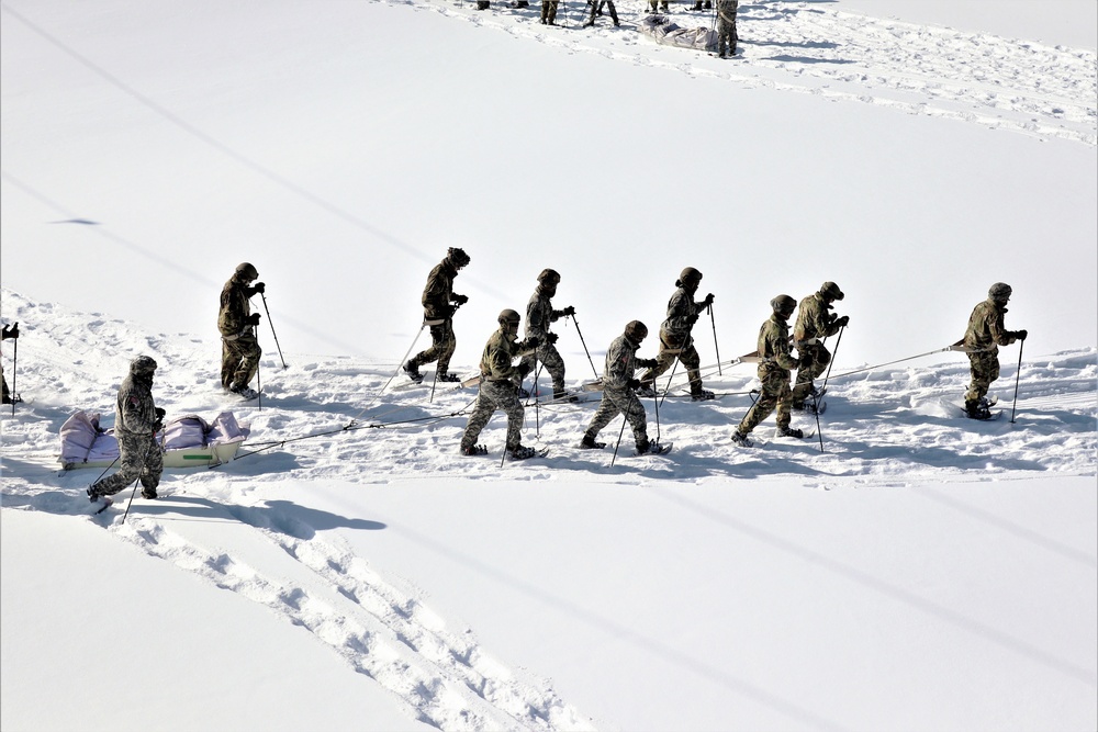 Cold-Weather Operations Course class 21-04 students conduct field training in snowshoes, pulling sleds