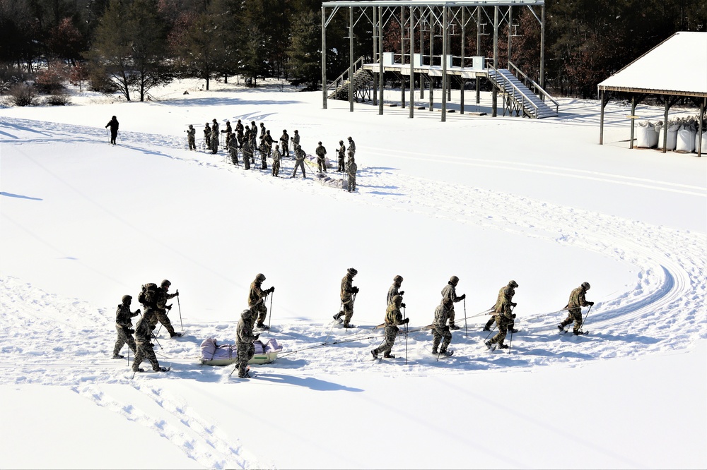 Cold-Weather Operations Course class 21-04 students conduct field training in snowshoes, pulling sleds