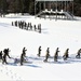 Cold-Weather Operations Course class 21-04 students conduct field training in snowshoes, pulling sleds