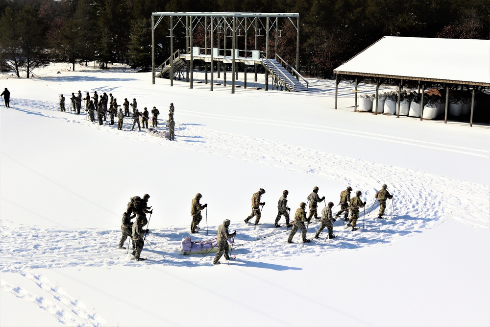 Cold-Weather Operations Course class 21-04 students conduct field training in snowshoes, pulling sleds