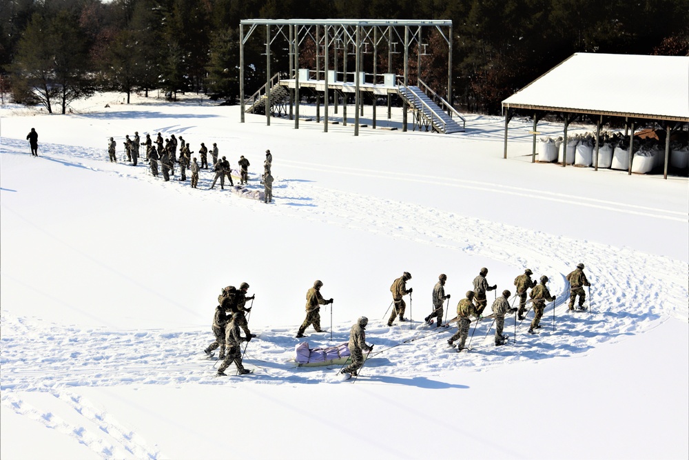 Cold-Weather Operations Course class 21-04 students conduct field training in snowshoes, pulling sleds