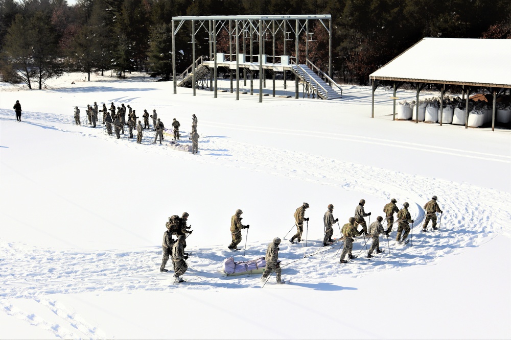 Cold-Weather Operations Course class 21-04 students conduct field training in snowshoes, pulling sleds