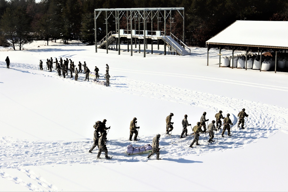 Cold-Weather Operations Course class 21-04 students conduct field training in snowshoes, pulling sleds