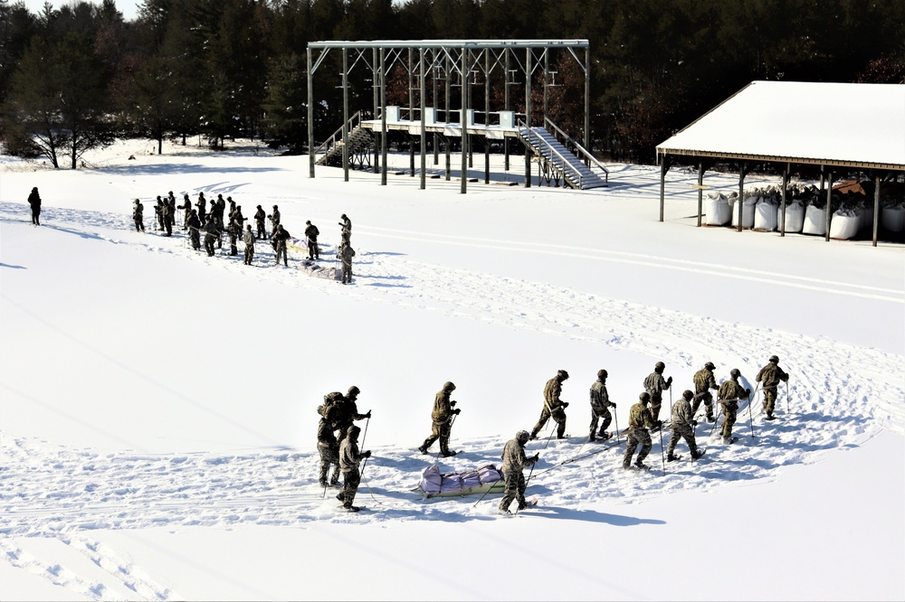 Cold-Weather Operations Course class 21-04 students conduct field training in snowshoes, pulling sleds