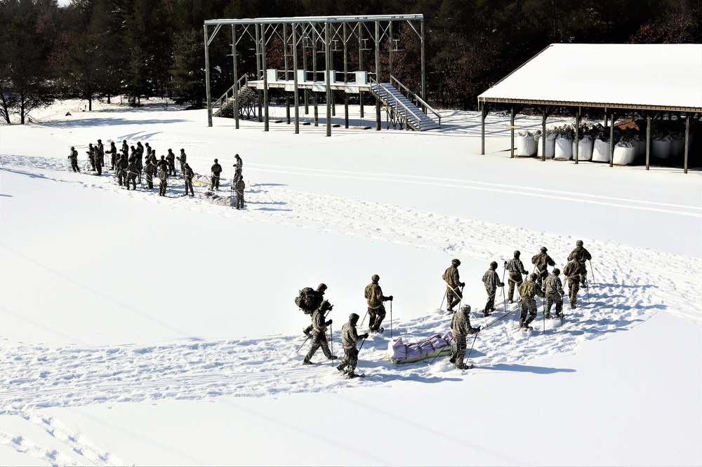 Cold-Weather Operations Course class 21-04 students conduct field training in snowshoes, pulling sleds