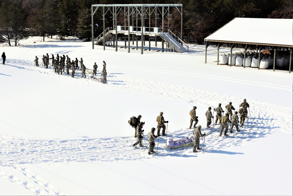 Cold-Weather Operations Course class 21-04 students conduct field training in snowshoes, pulling sleds