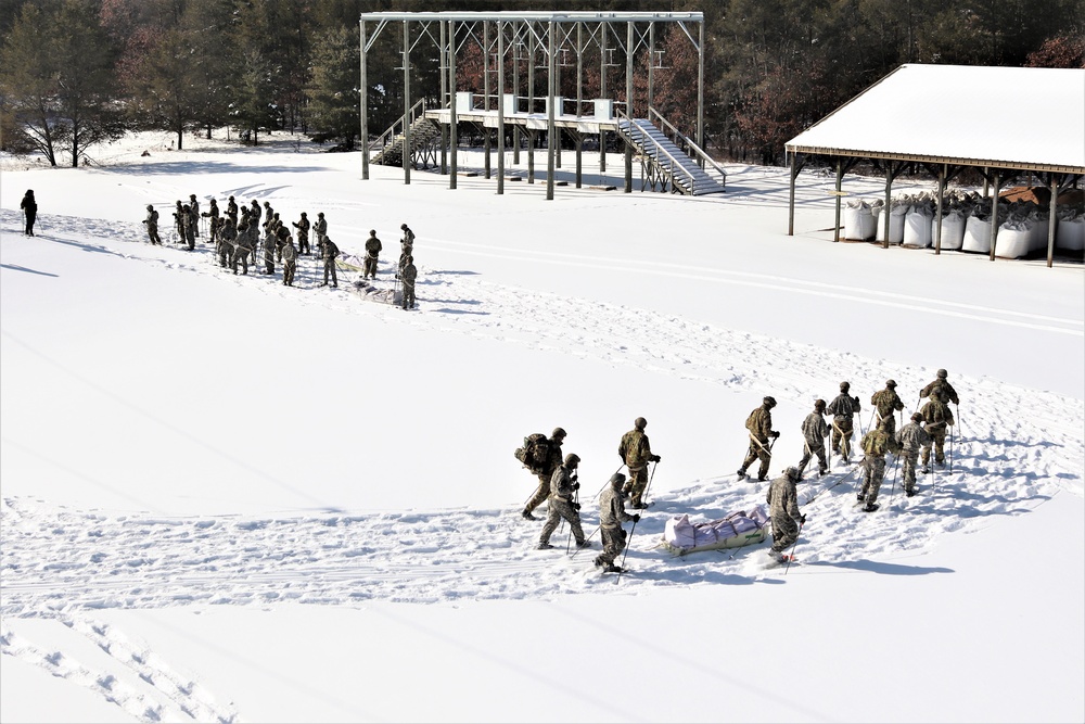 Cold-Weather Operations Course class 21-04 students conduct field training in snowshoes, pulling sleds