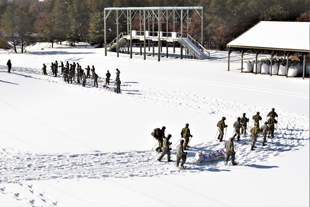 Cold-Weather Operations Course class 21-04 students conduct field training in snowshoes, pulling sleds