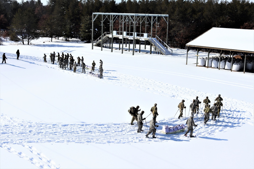 Cold-Weather Operations Course class 21-04 students conduct field training in snowshoes, pulling sleds