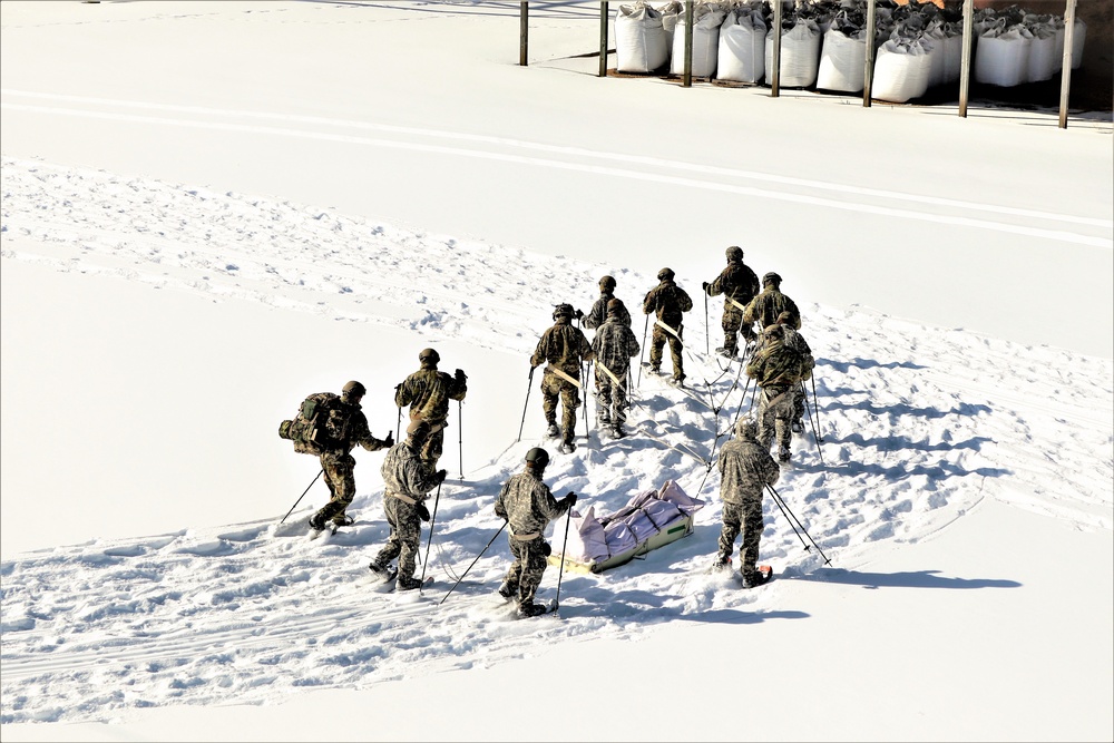 Cold-Weather Operations Course class 21-04 students conduct field training in snowshoes, pulling sleds