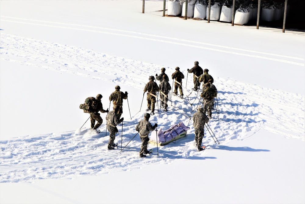 Cold-Weather Operations Course class 21-04 students conduct field training in snowshoes, pulling sleds