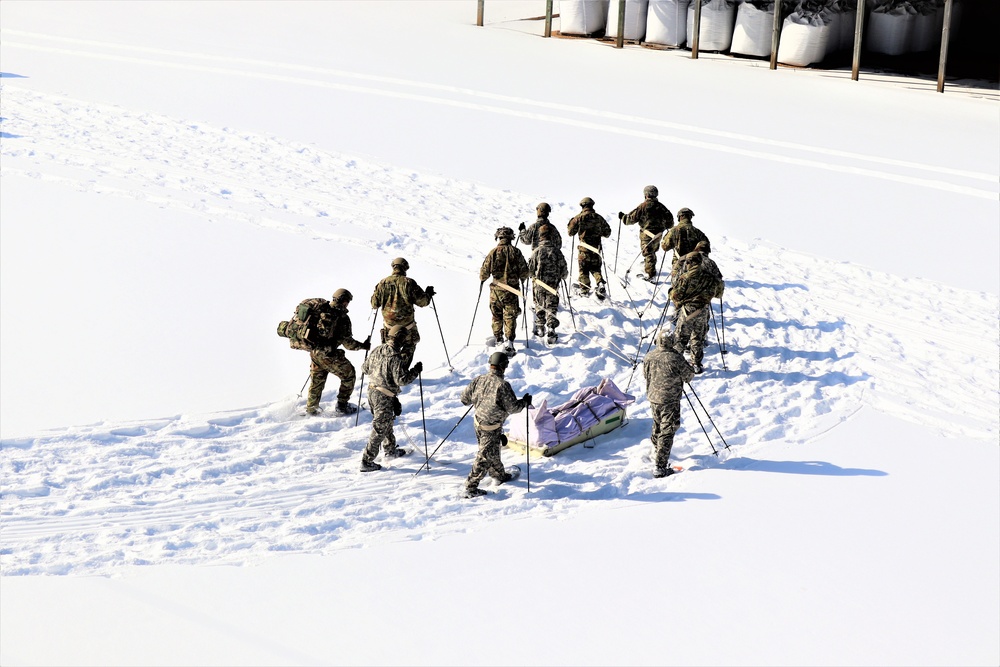 Cold-Weather Operations Course class 21-04 students conduct field training in snowshoes, pulling sleds