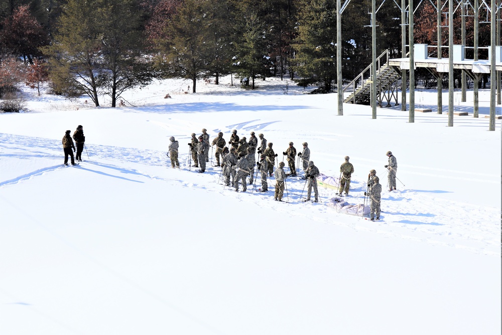 Cold-Weather Operations Course class 21-04 students conduct field training in snowshoes, pulling sleds