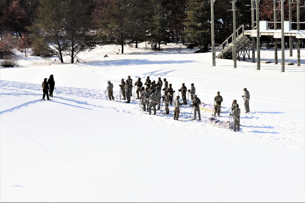 Cold-Weather Operations Course class 21-04 students conduct field training in snowshoes, pulling sleds