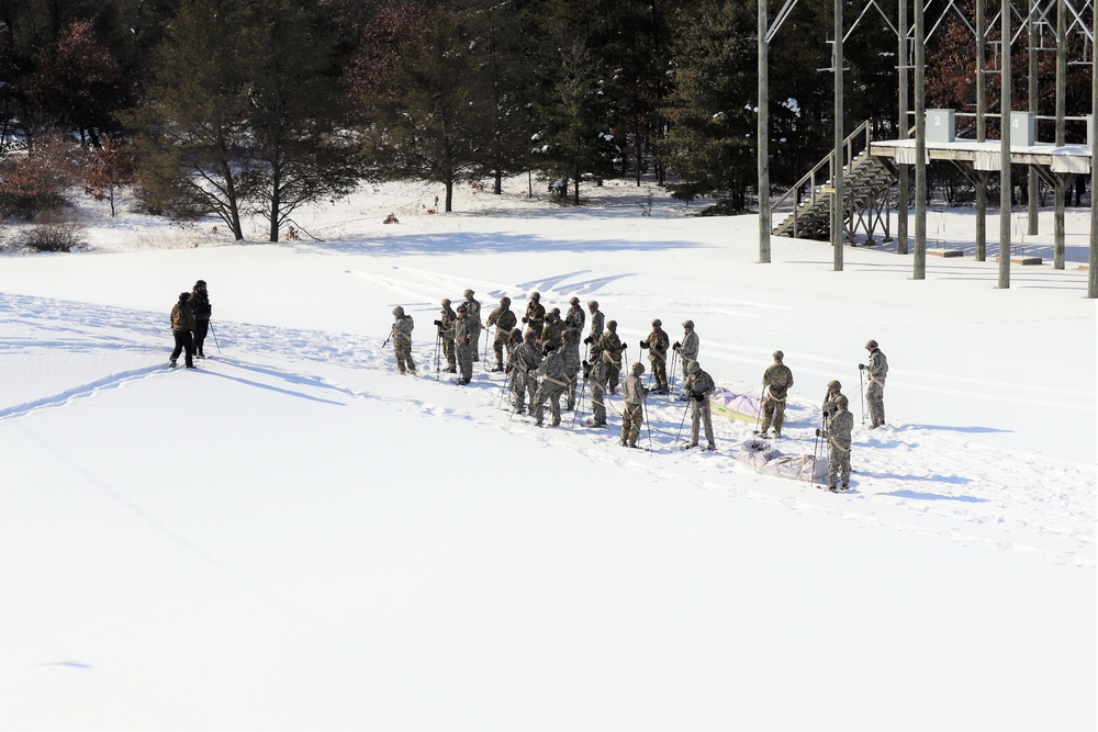 Cold-Weather Operations Course class 21-04 students conduct field training in snowshoes, pulling sleds