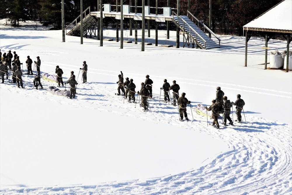 Cold-Weather Operations Course class 21-04 students conduct field training in snowshoes, pulling sleds