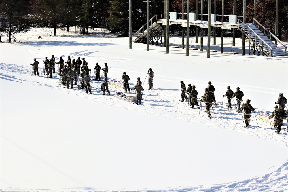 Cold-Weather Operations Course class 21-04 students conduct field training in snowshoes, pulling sleds