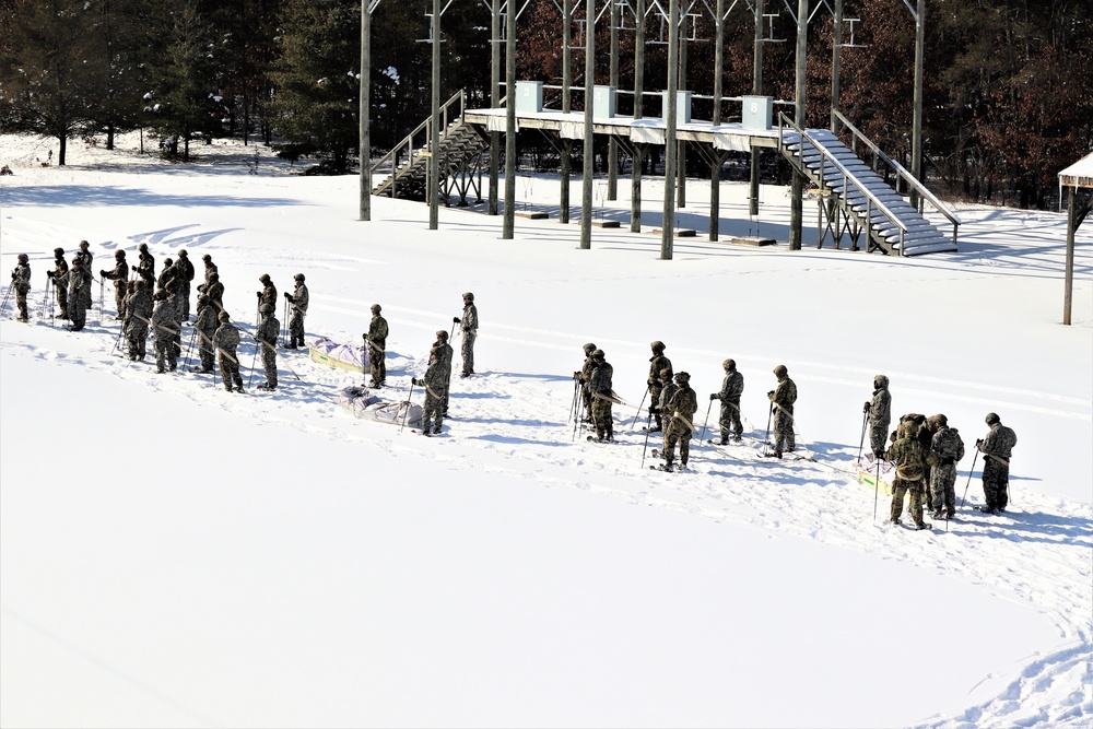 Cold-Weather Operations Course class 21-04 students conduct field training in snowshoes, pulling sleds