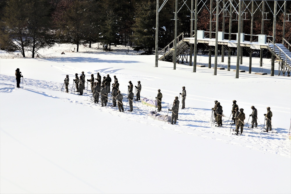 Cold-Weather Operations Course class 21-04 students conduct field training in snowshoes, pulling sleds